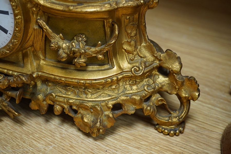 An early 20th century French ormolu clock surmounted with a boy and dog, striking on a bell, 41cm wide. Condition - fair, one hand missing, untested